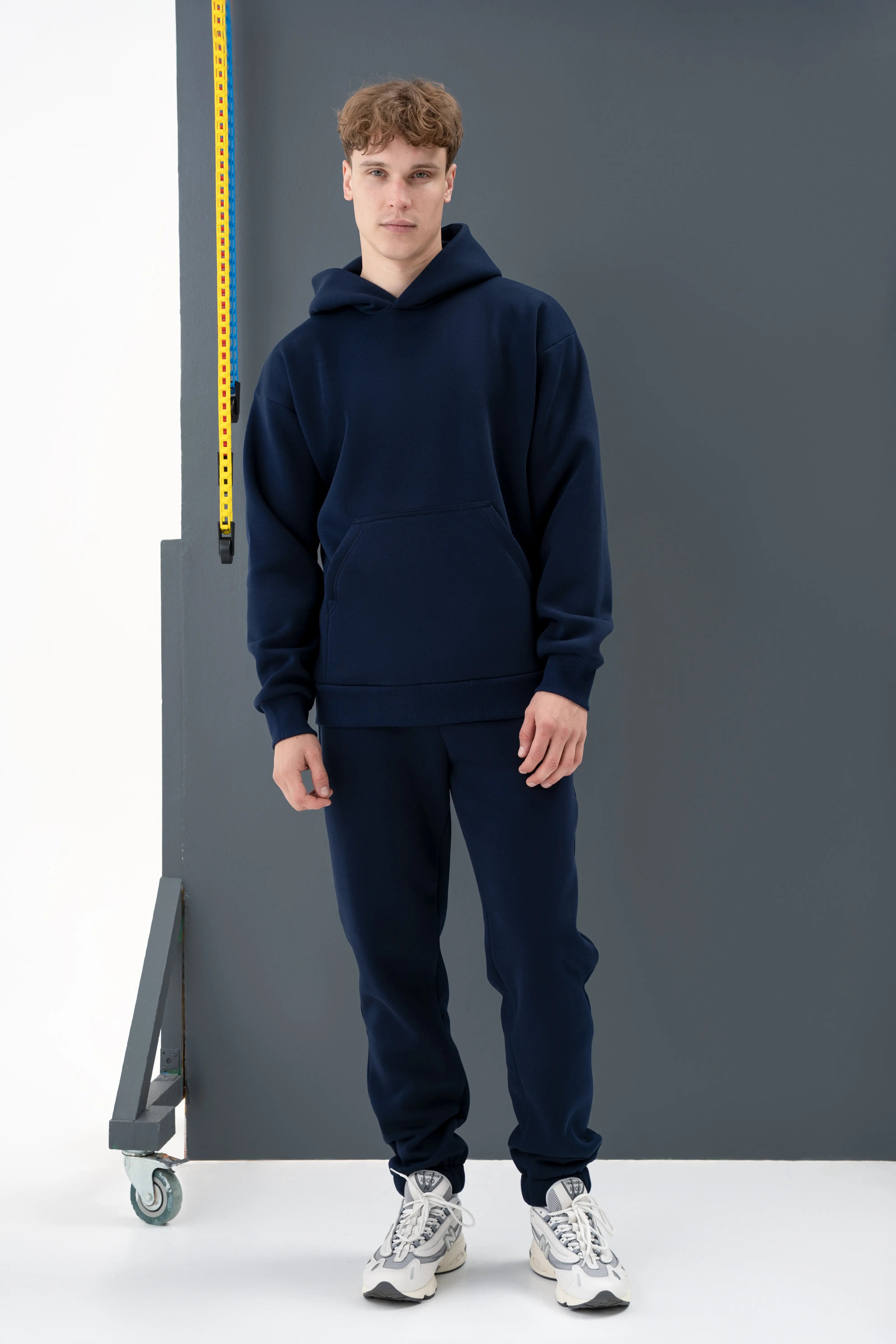 A dark blue men’s casual tracksuit with a hood, made in the cutmyfashion sewing workshop in Lithuania.