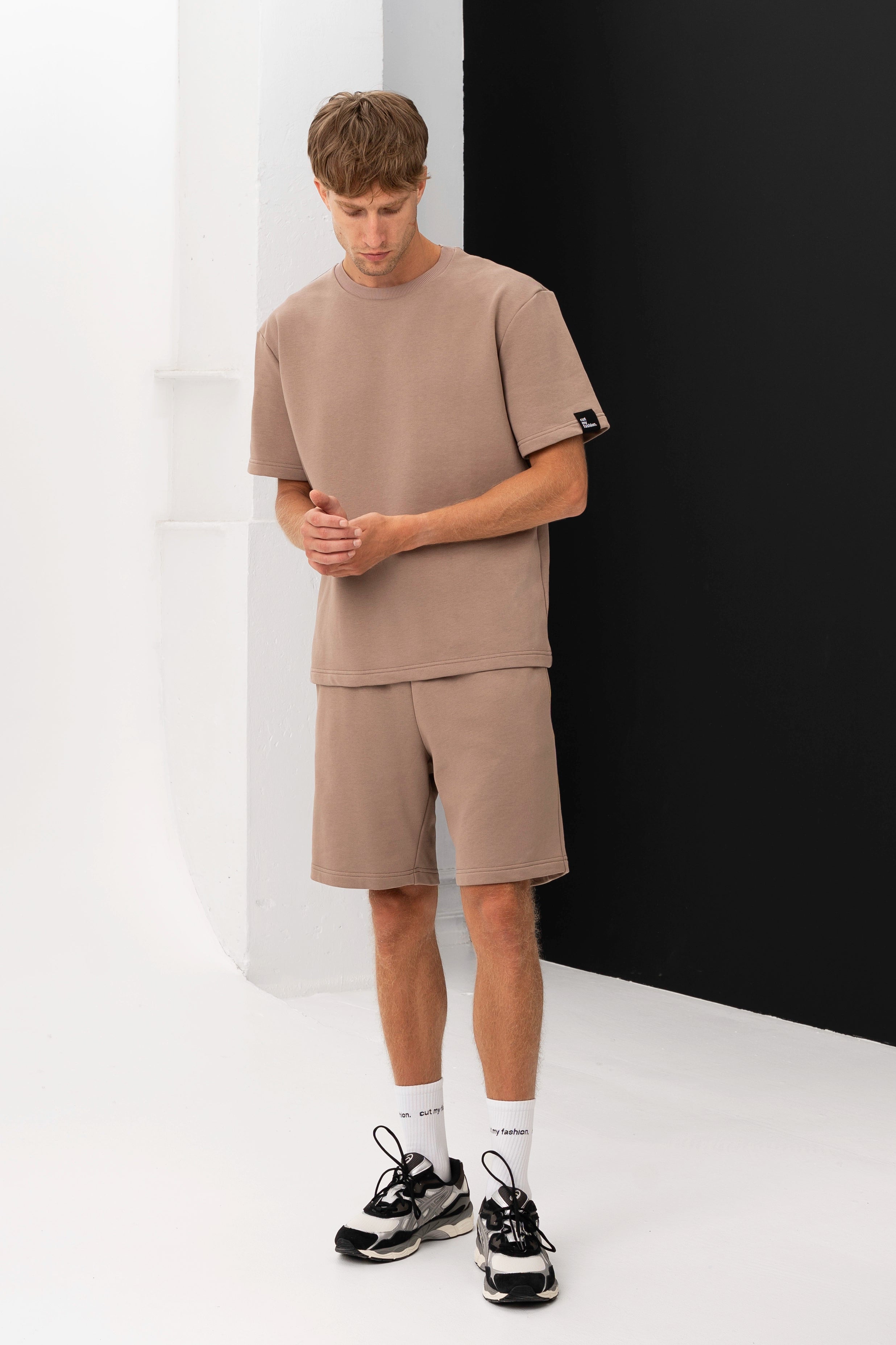 Men’s casual outfit set – a T-shirt and shorts made from soft fabric, posed against a black and white background