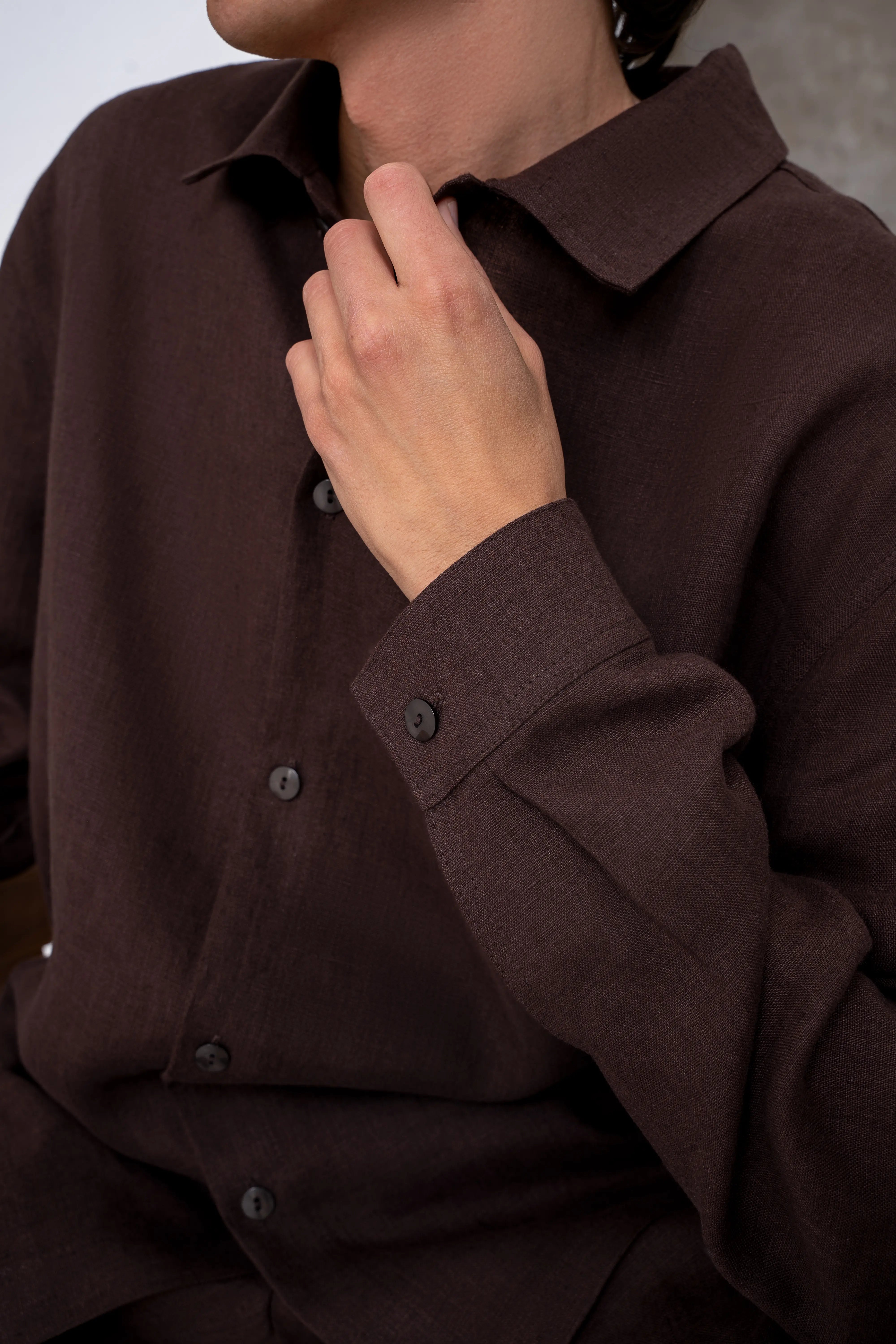 Men’s brown linen shirt shown closer up, relaxed silhouette and button-up front