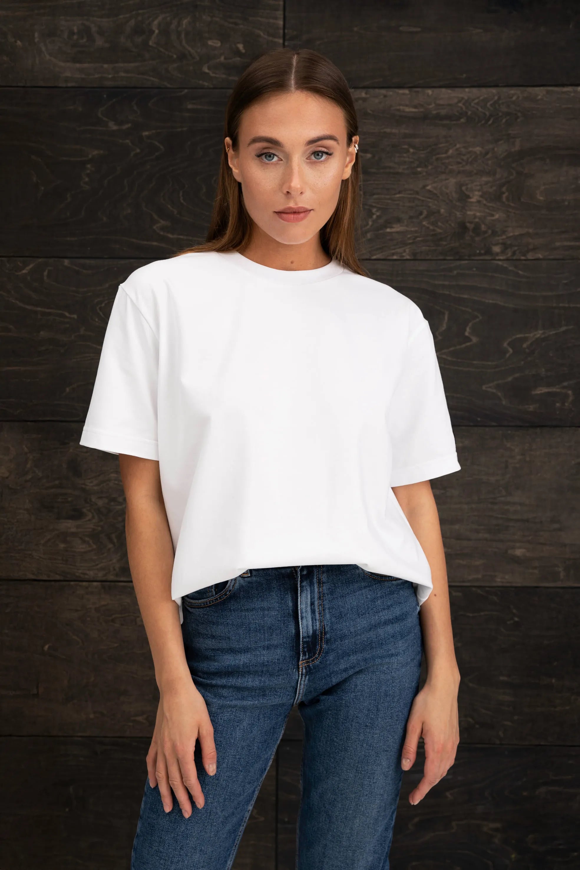 Women's white T-shirt with a round neckline and an oversized silhouette.