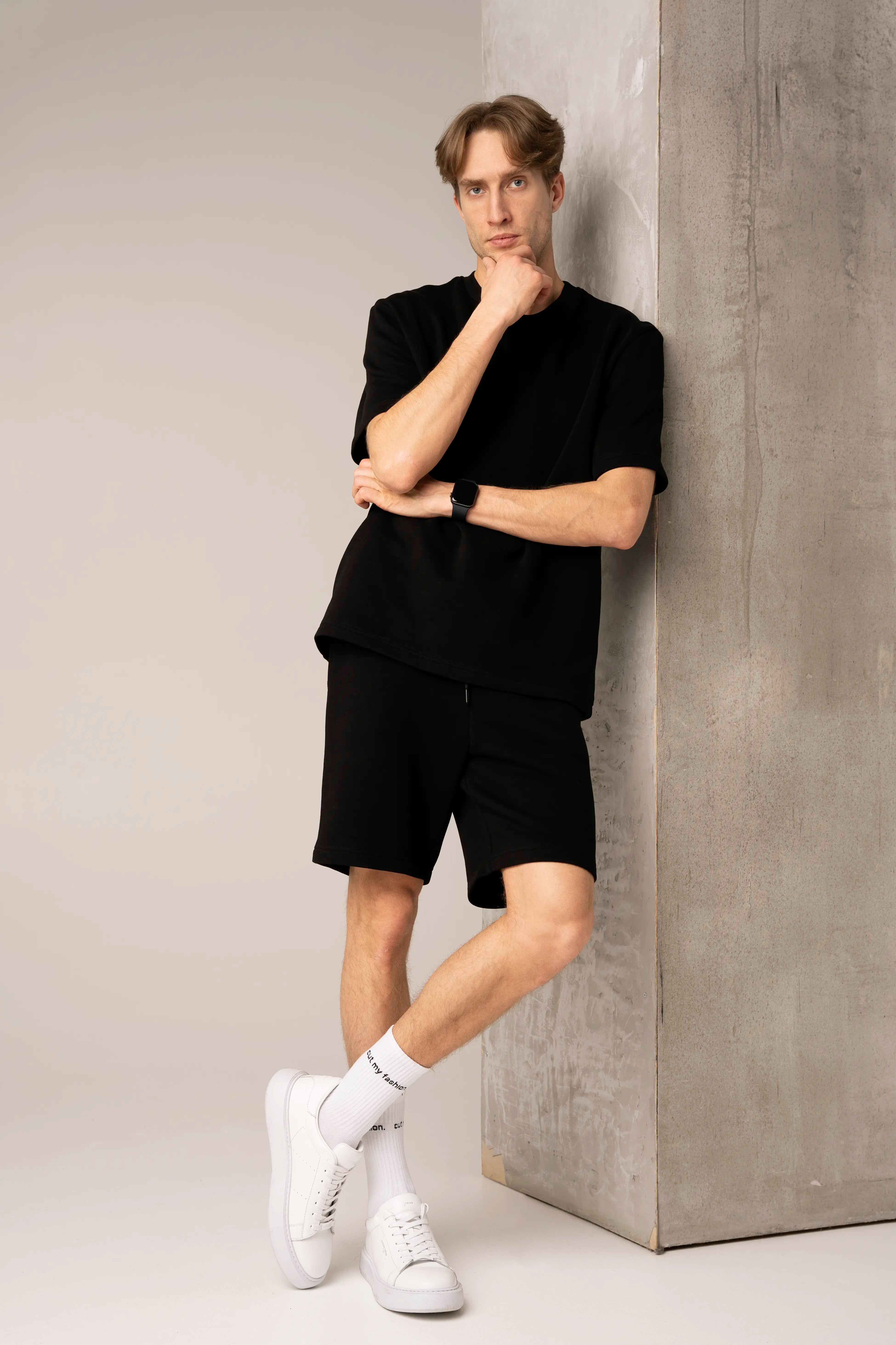 Men's black casual tracksuit with a T-shirt and shorts with pockets.